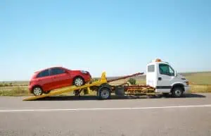 flatbed loading up red car