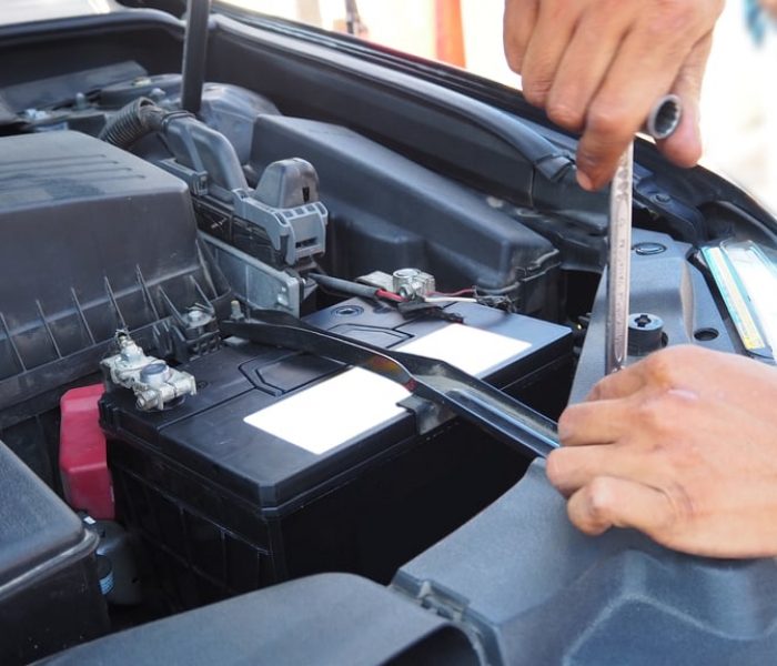 Car,Battery,,fitting,A,Car,Battery,With,Wrench,And,Checking